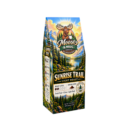 A package of Moose & Mug Sunrise Trail Light Roast coffee, featuring a colorful mountain and forest landscape illustration on the front and side panels.